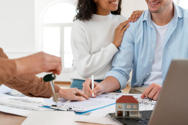 smiley couple signing contract new house